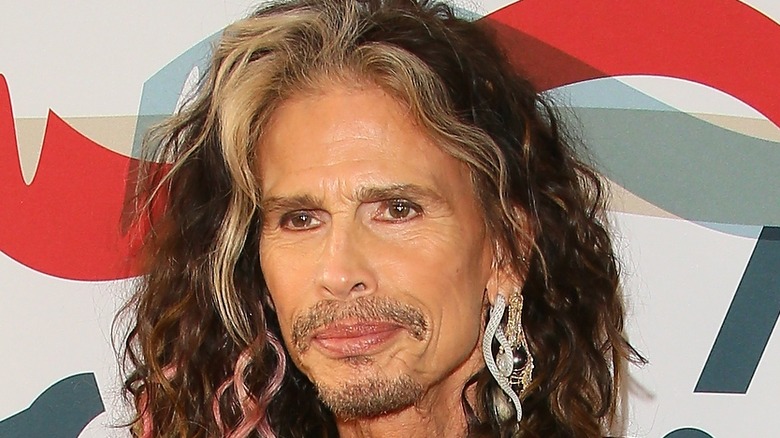 Steven Tyler posing at charity event