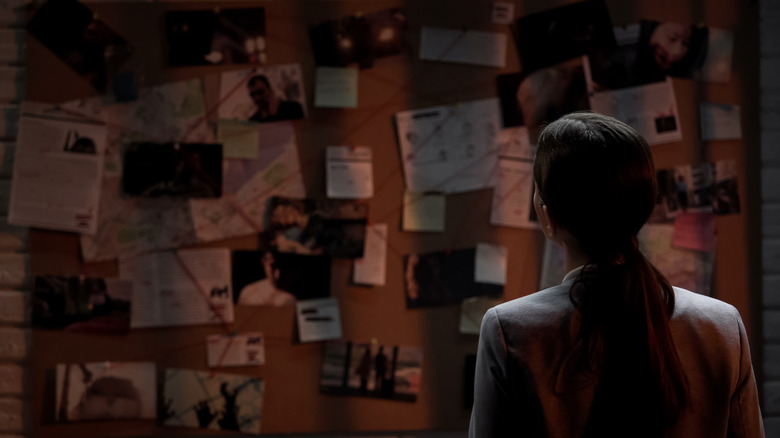 Examining cork board of evidence