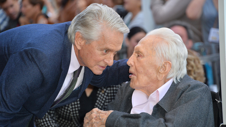 Michael Douglas leaning towards Kirk Douglas