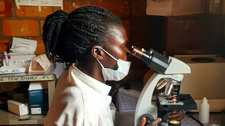 Female lab technician at microscope