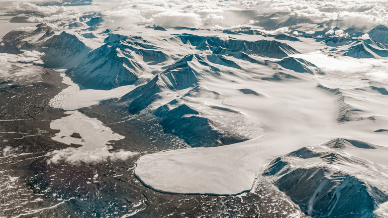Aerial view of rock and snow in Antarctic desert region.