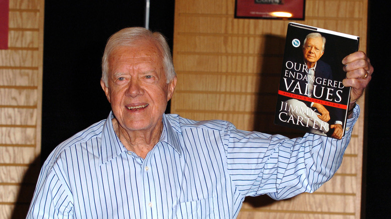 Jimmy Carter smiling with book