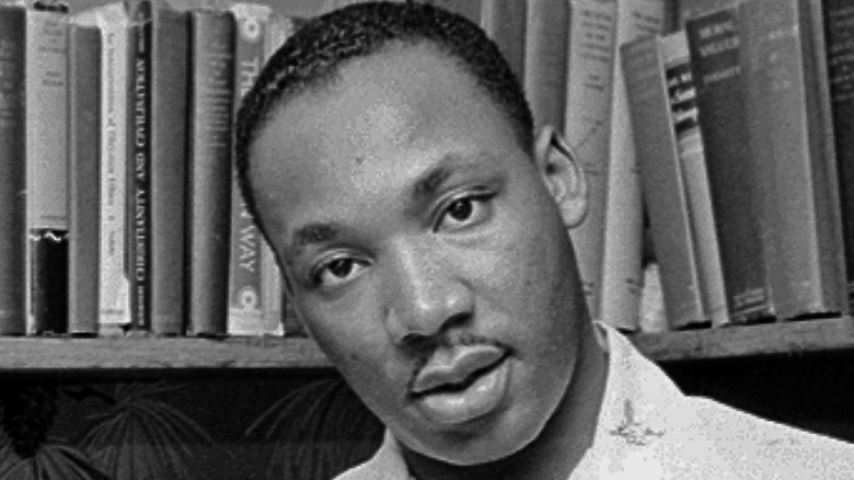 Martin Luther King Jr. surrounded by books