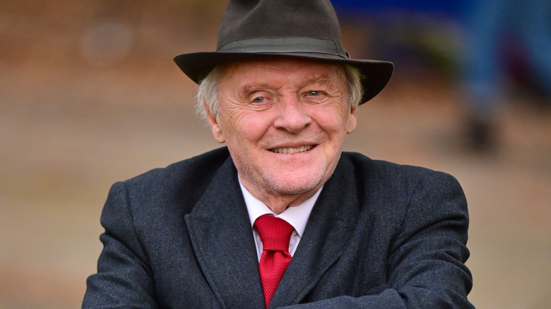 Anthony Hopkins hat suit red tie smiling