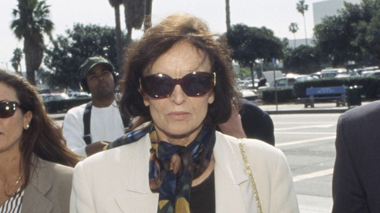 Judi Brown, mother of Nicole Brown Simpson, wearing sunglasses and scarf.