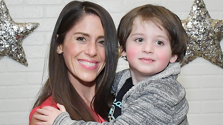 soleil moon frye smiling holding child
