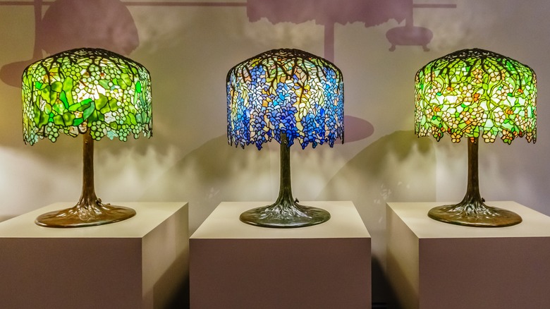 Three Tiffany lamps on pedestals