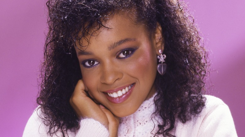 Ola Ray hand cheek