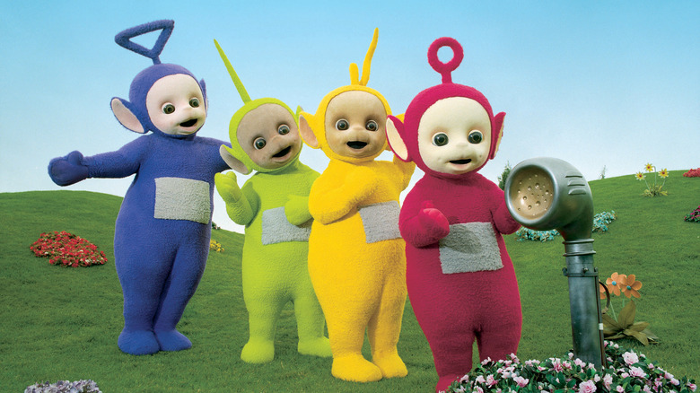Teletubbies cast near a speaker