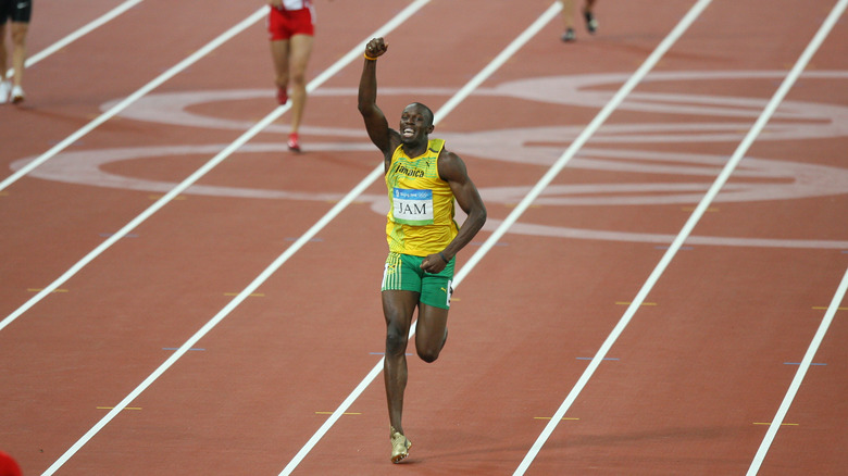 Usain Bolt, arm raised in triumph