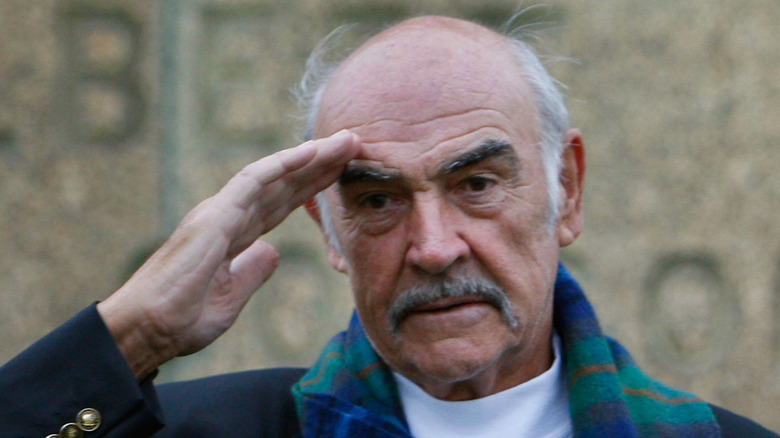 Sean Connery salutes at a book signing