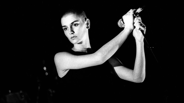 Sinead O'Connor performing holding microphone
