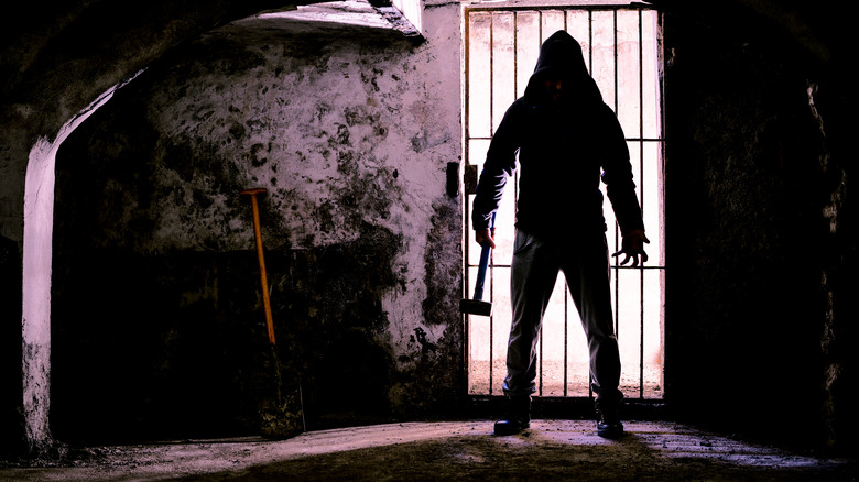 silhouette of man holding hammer