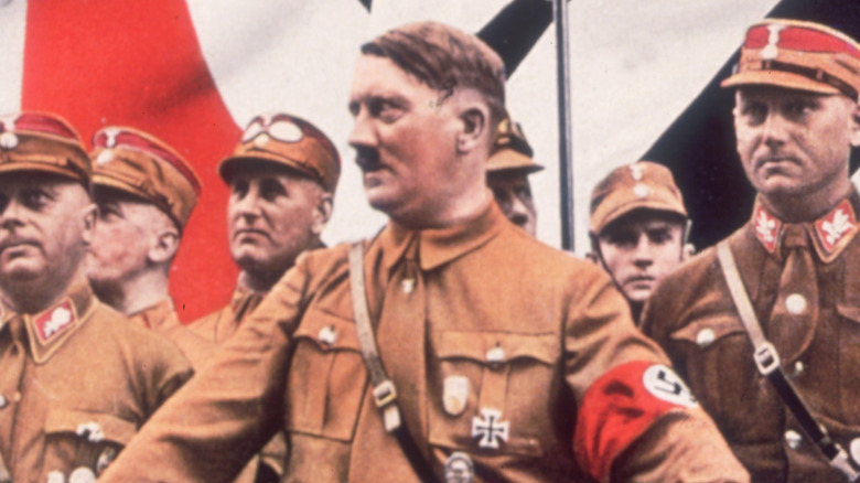 Adolf Hitler surrounded by Nazi officers