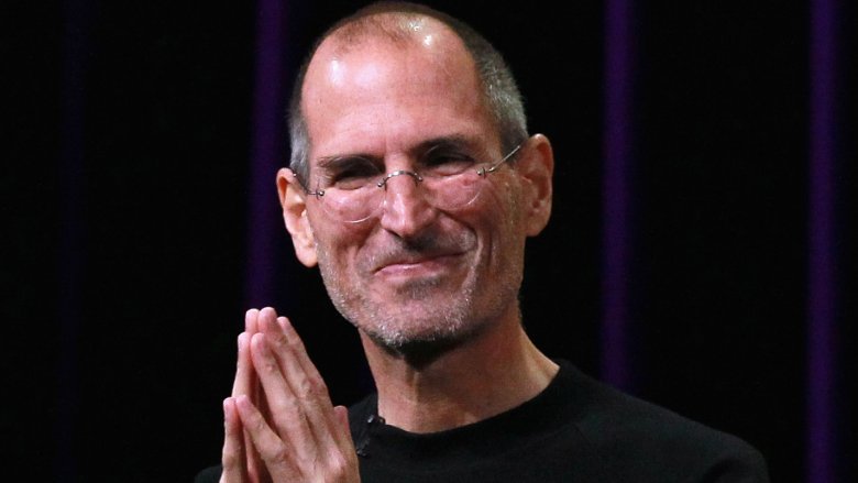 Steve Jobs smiling hands clasped