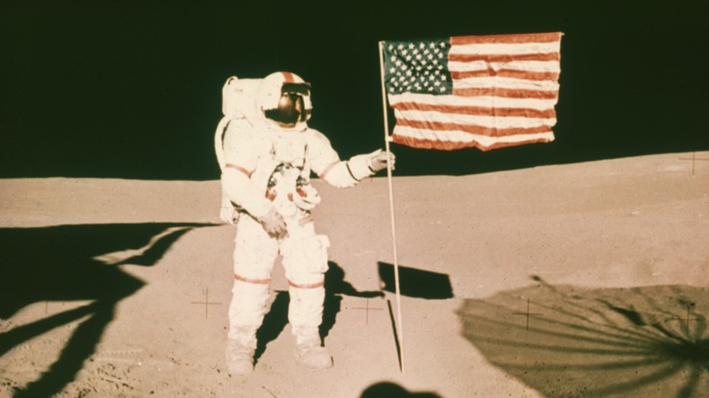 Alan Shepard holding an American flag on the Moon