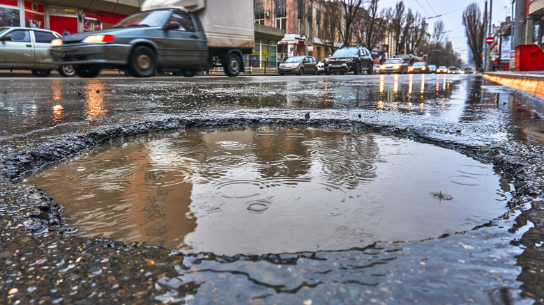 pothole in road with traffic
