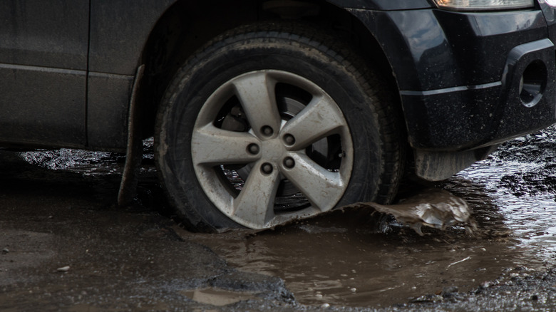 car tire in pothole