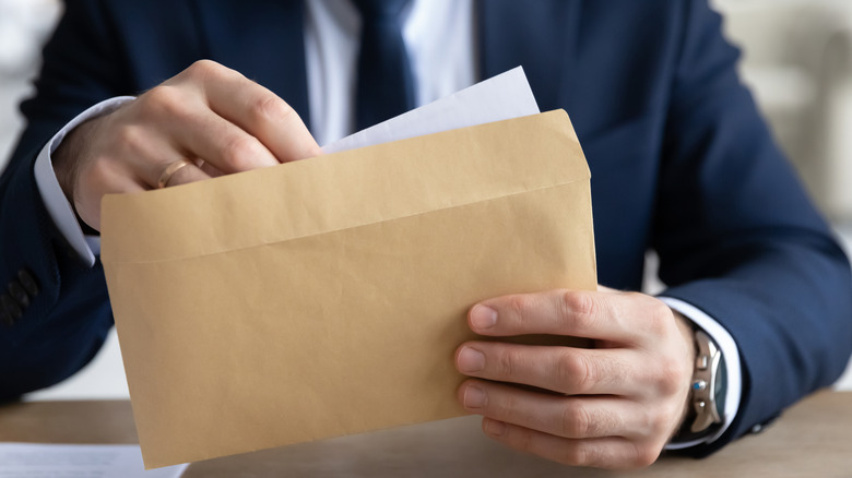 Person opening envelope