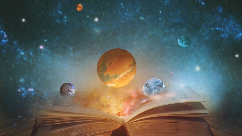 Open book with planets floating out of it