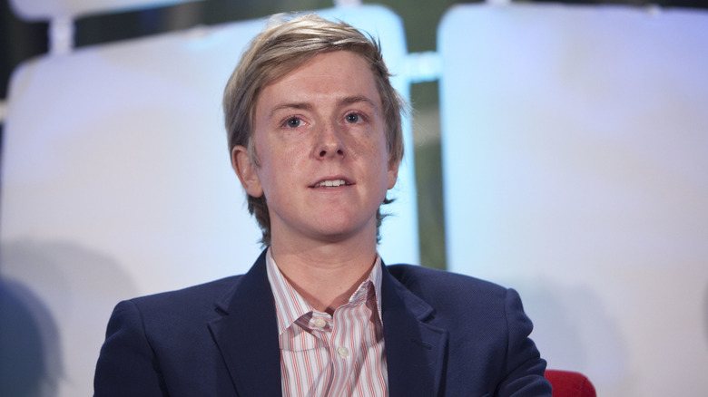 chris hughes in suit jacket and striped shirt