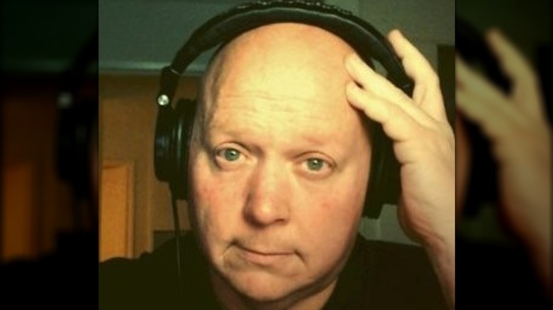 Daniel Neff smirking in headphones
