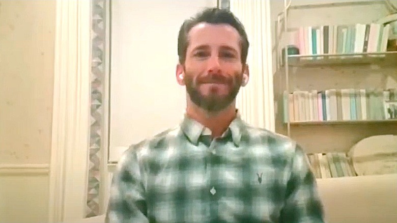 ezra callahan in plaid shirt for podcast interview