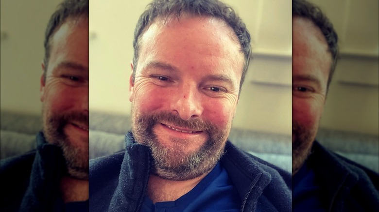 Gilles Mischler smiling in sweatshirt