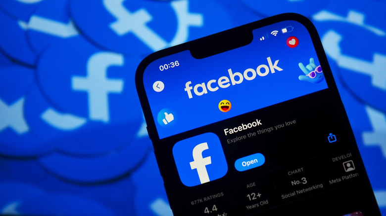 facebook app on phone against background of facebook logos