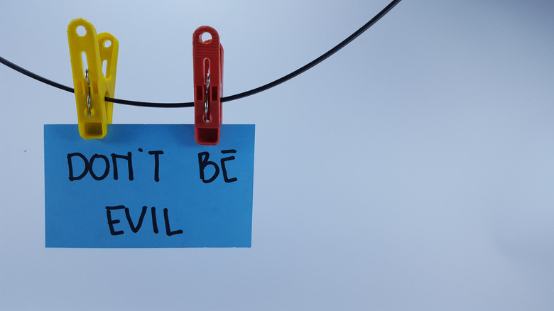 google don't be evil slogan on blue note hanging on pegs