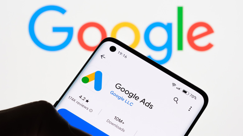 Google Ads on phone against Google Ads backdrop