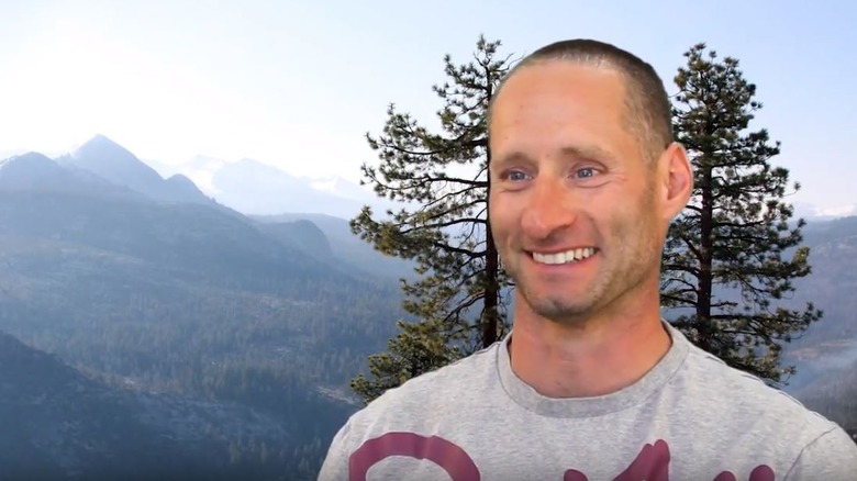 ray sidney smiling in T-shirt by wilderness landscape