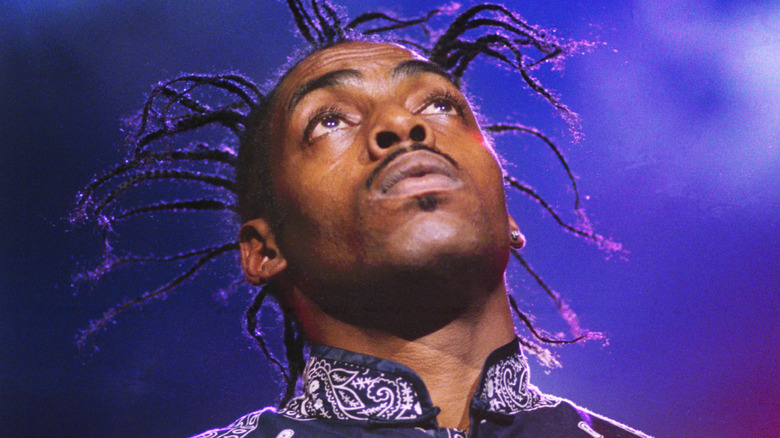 Coolio with wild hair looking upwards