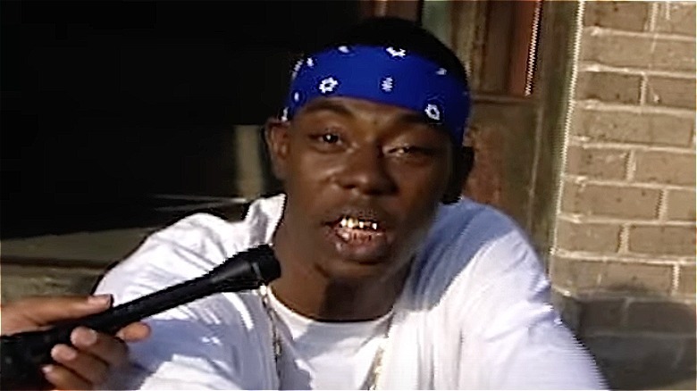 Soulja Slim giving interview wearing white t-shirt and blue bandana