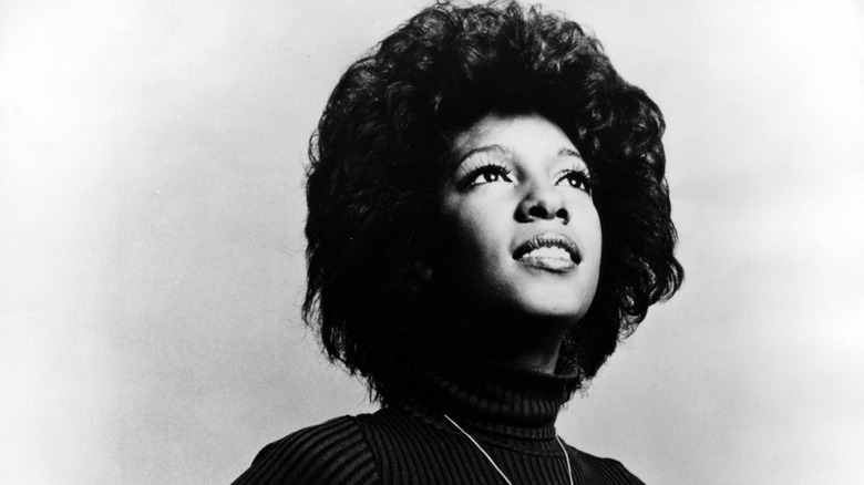 Mary wilson looking up wearing turtleneck