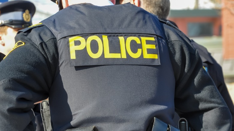 back of police man in uniform