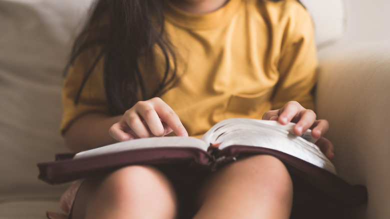 a child studying the Bible