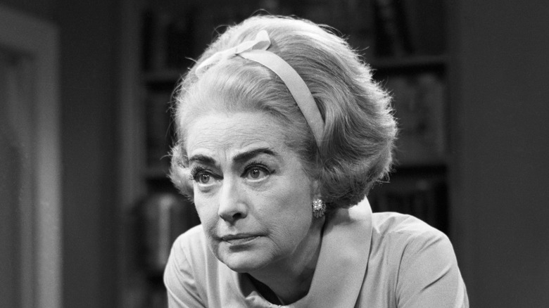 Joan Crawford frowning with beehive hair