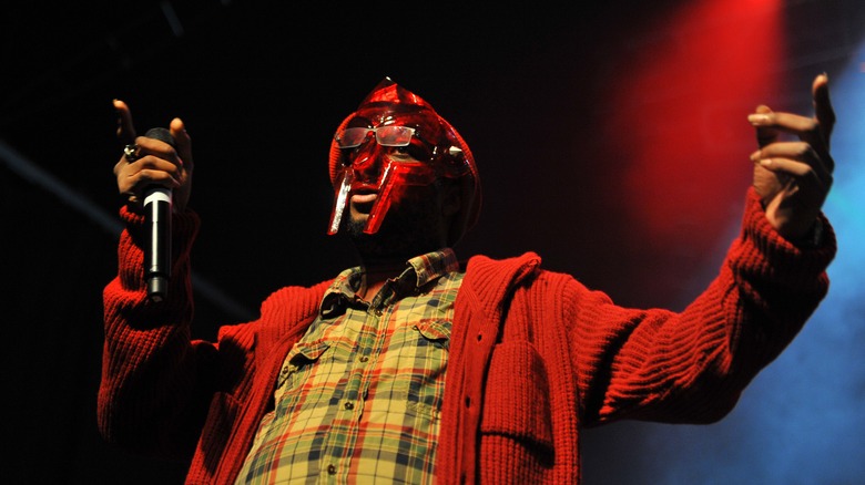 MF DOOM in mask onstage with mic