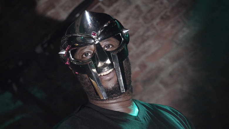 MF DOOM in mask onstage with mic