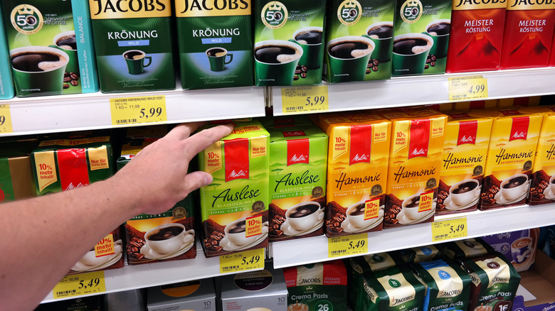 man grabbing box of instant coffee