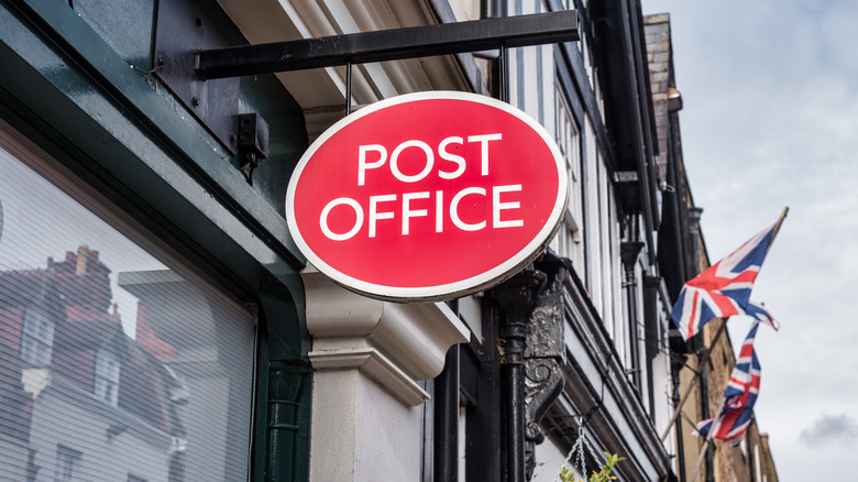 Post office sign with UK flag in background