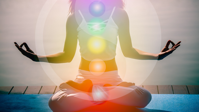 Yoga pose woman with overlaid chakras