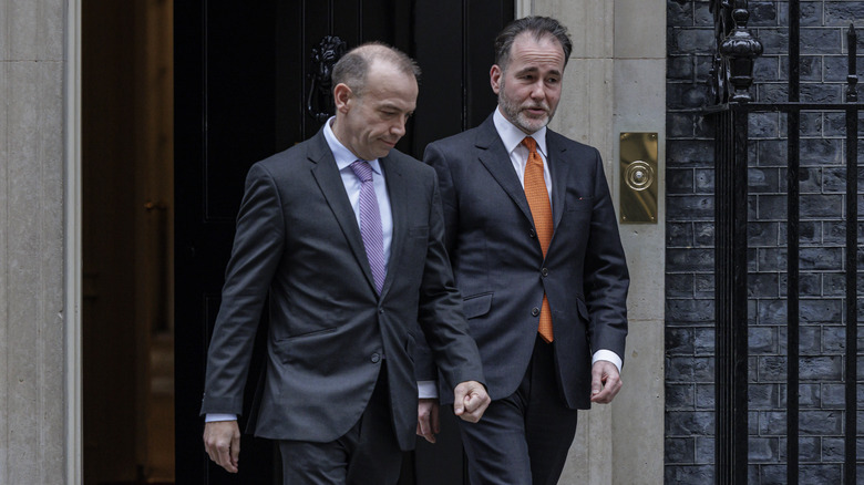 Pincher (right) leaving Downing Street