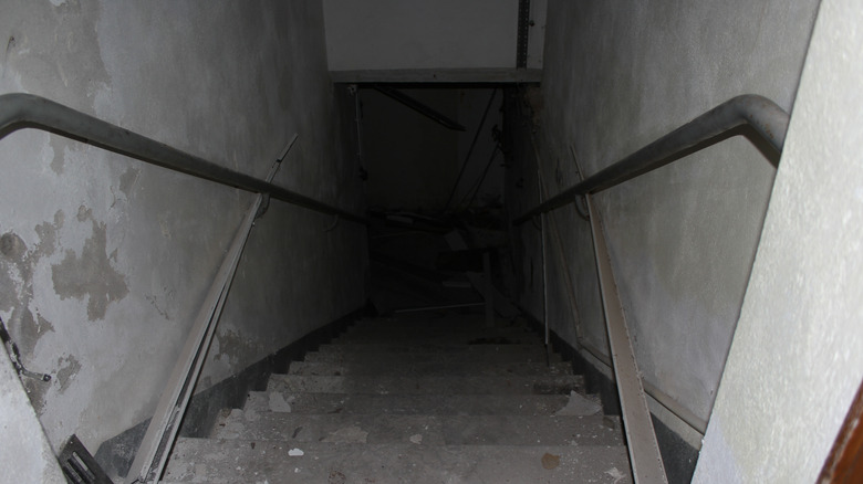 Dark entryway to dirty basement