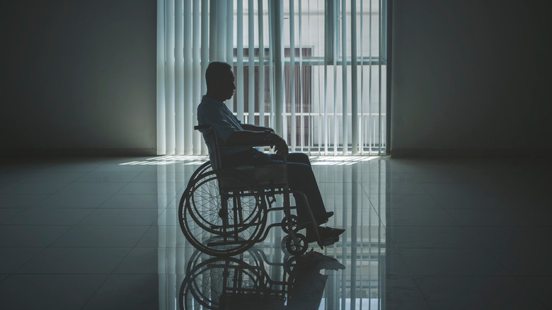 man wheelchair sad dark