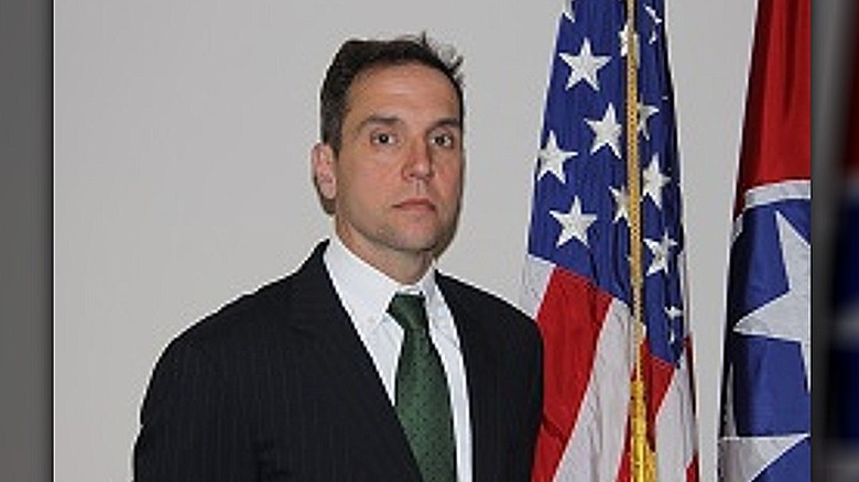 Jack Smith beside american flag