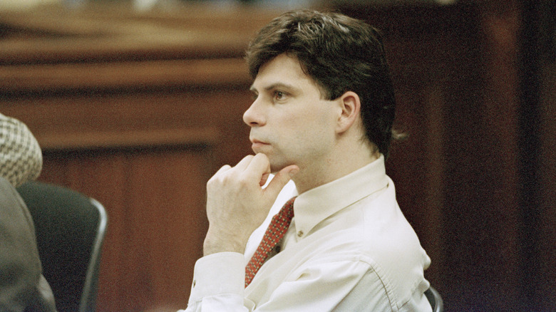 Lyle Menendez in court resting hand on face
