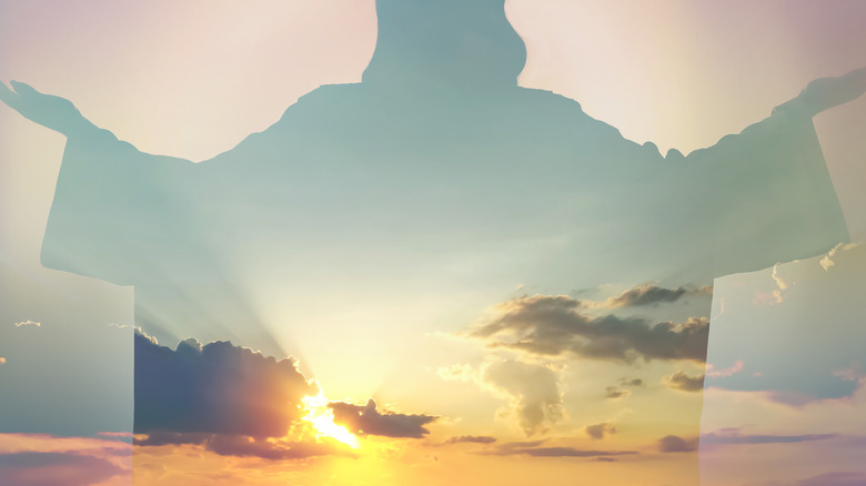 Jesus silhouette against sunny sky