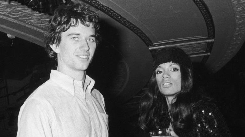young Robert F. Kennedy Jr. smiling with girlfriend